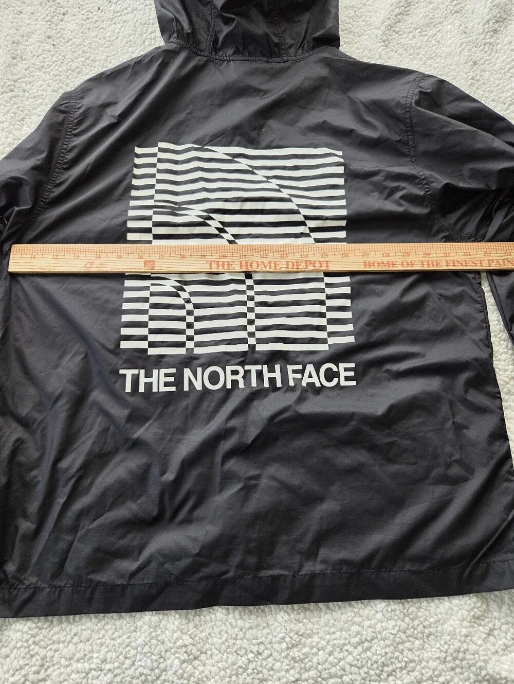 The North Face Optical Cyclone windbreaker features a distinctive optical illusi